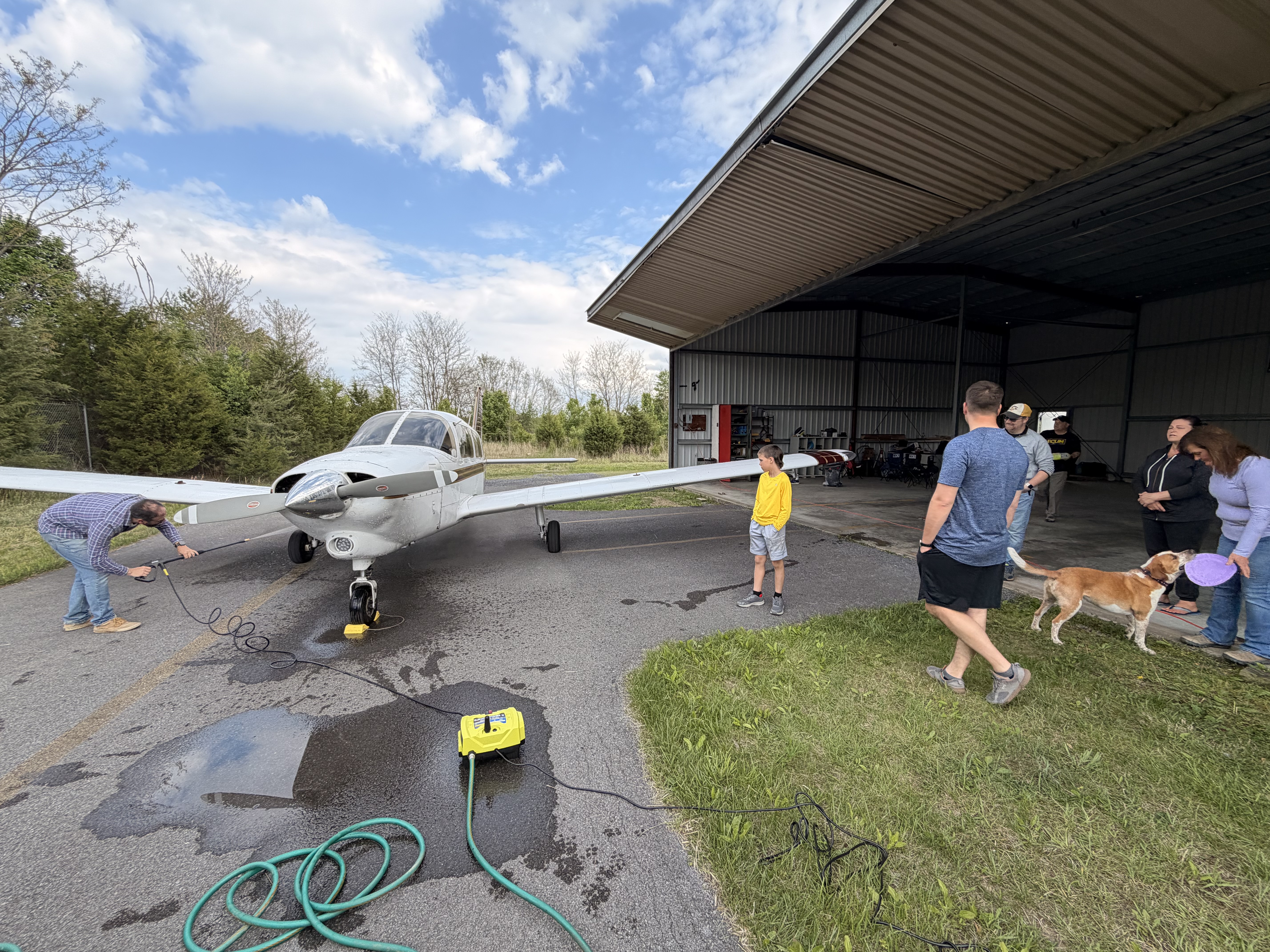 Members washing the Piper Dakota at the hangar